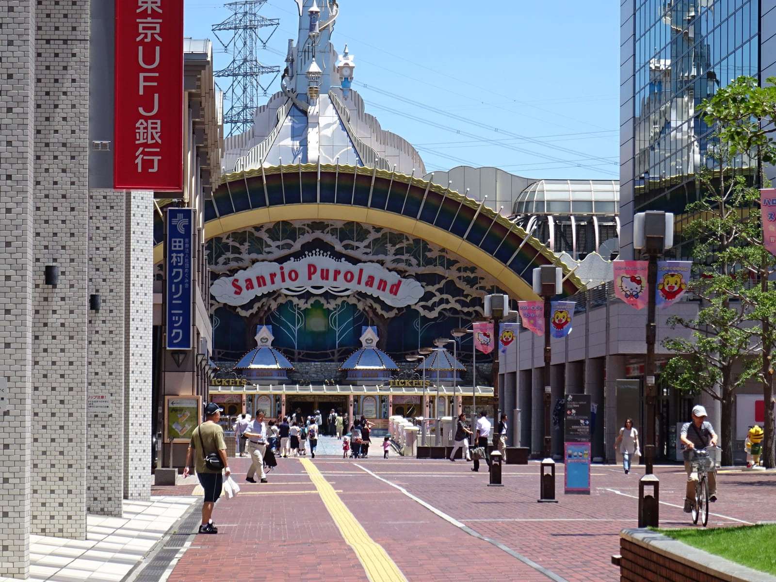 The pedestrian street from Tama Center Station to Sanrio Puroland, lined with character flags on lamp posts