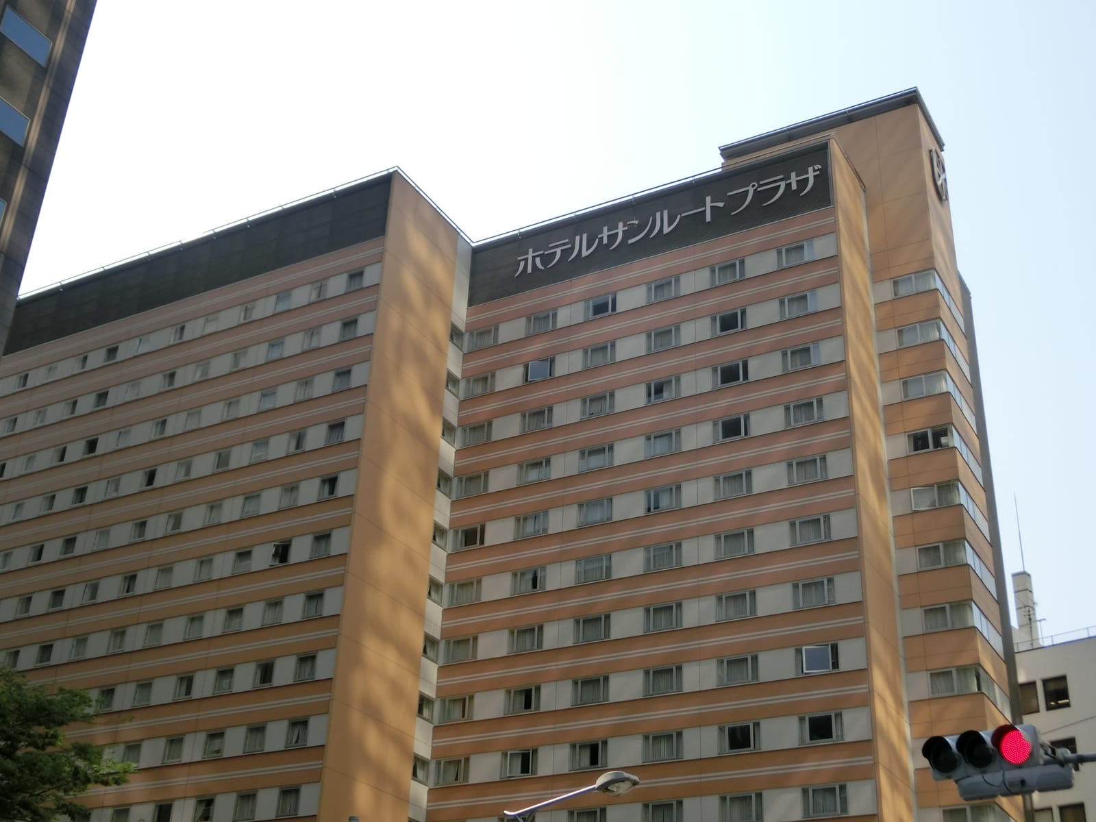 The tower of Hotel Sunroute Plaza Shinjuku with its rooftop name sign